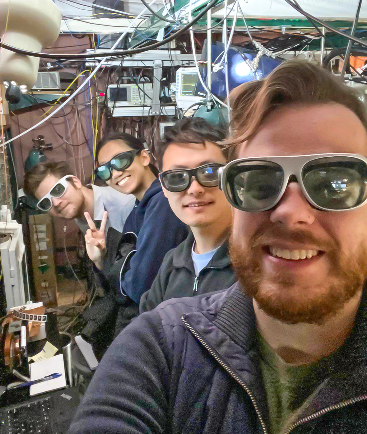 Selfie of four smiling researchers in a lab.