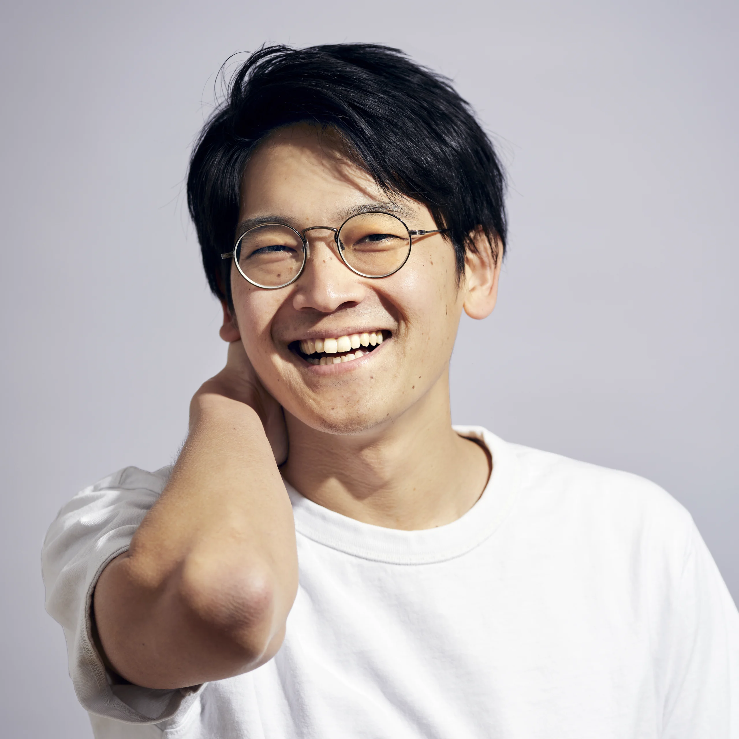 A portrait of Seiji Fujimoto wearing a white shirt.