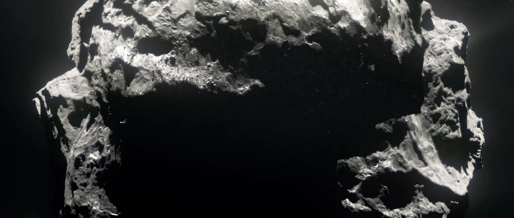 Black-and-white photo of a comet tumbling through space.