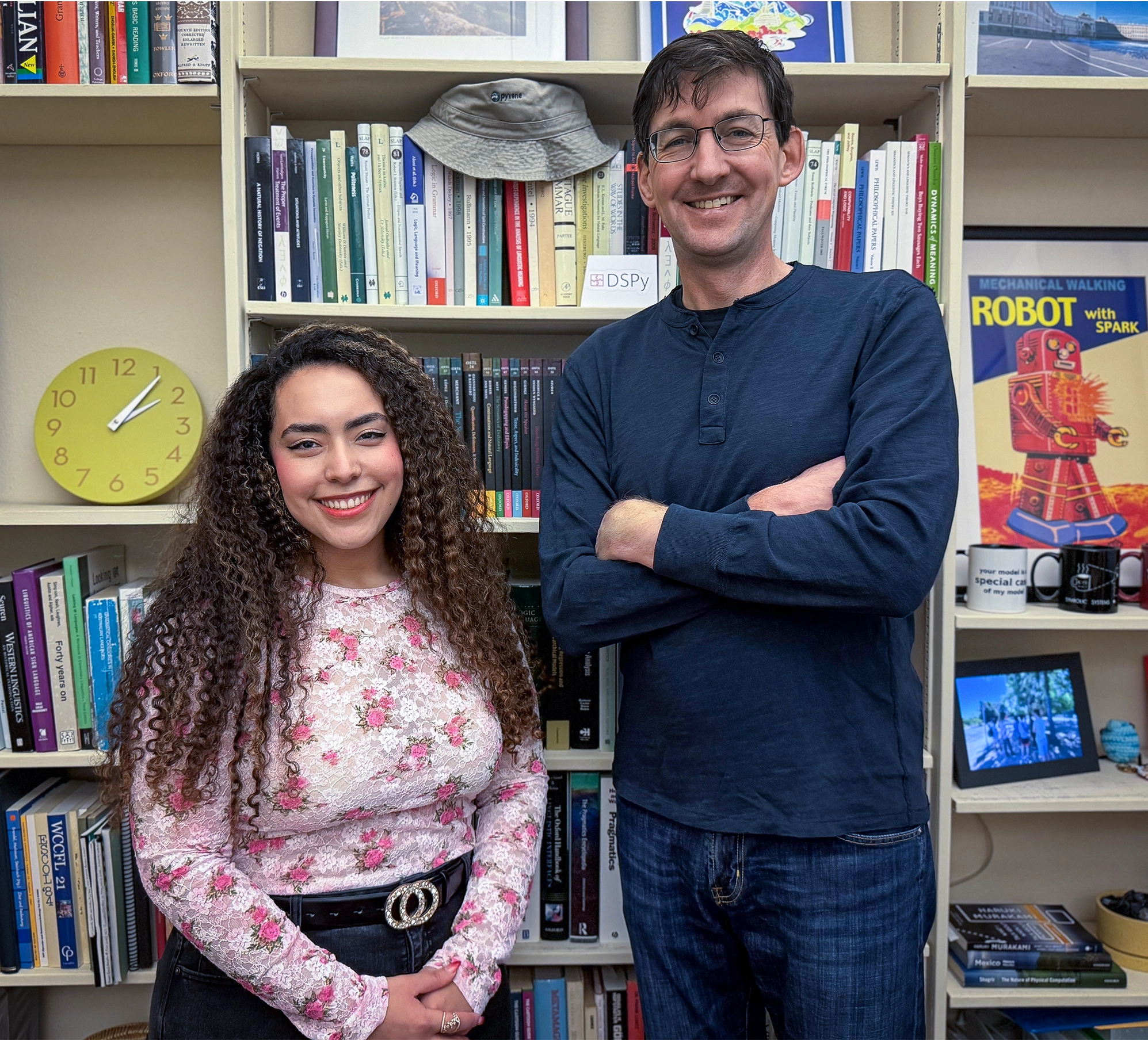 Julie Kallini and Christopher Potts in front of a full bookshelf