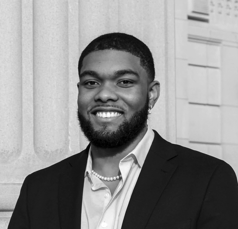 a man wearing a white shirt and black blazer