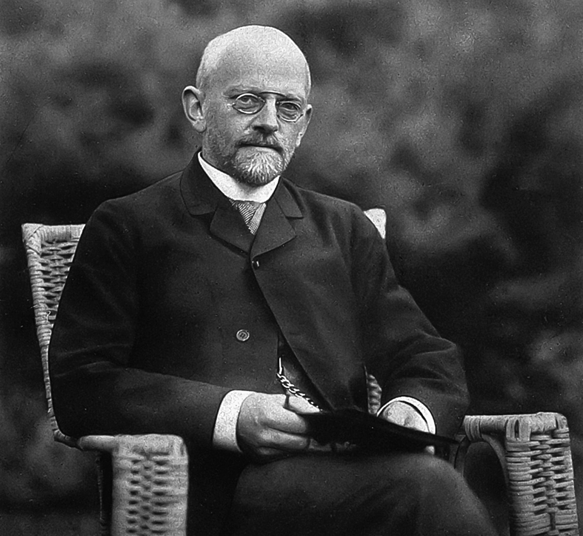 Black-and-white photograph of a man with a book.