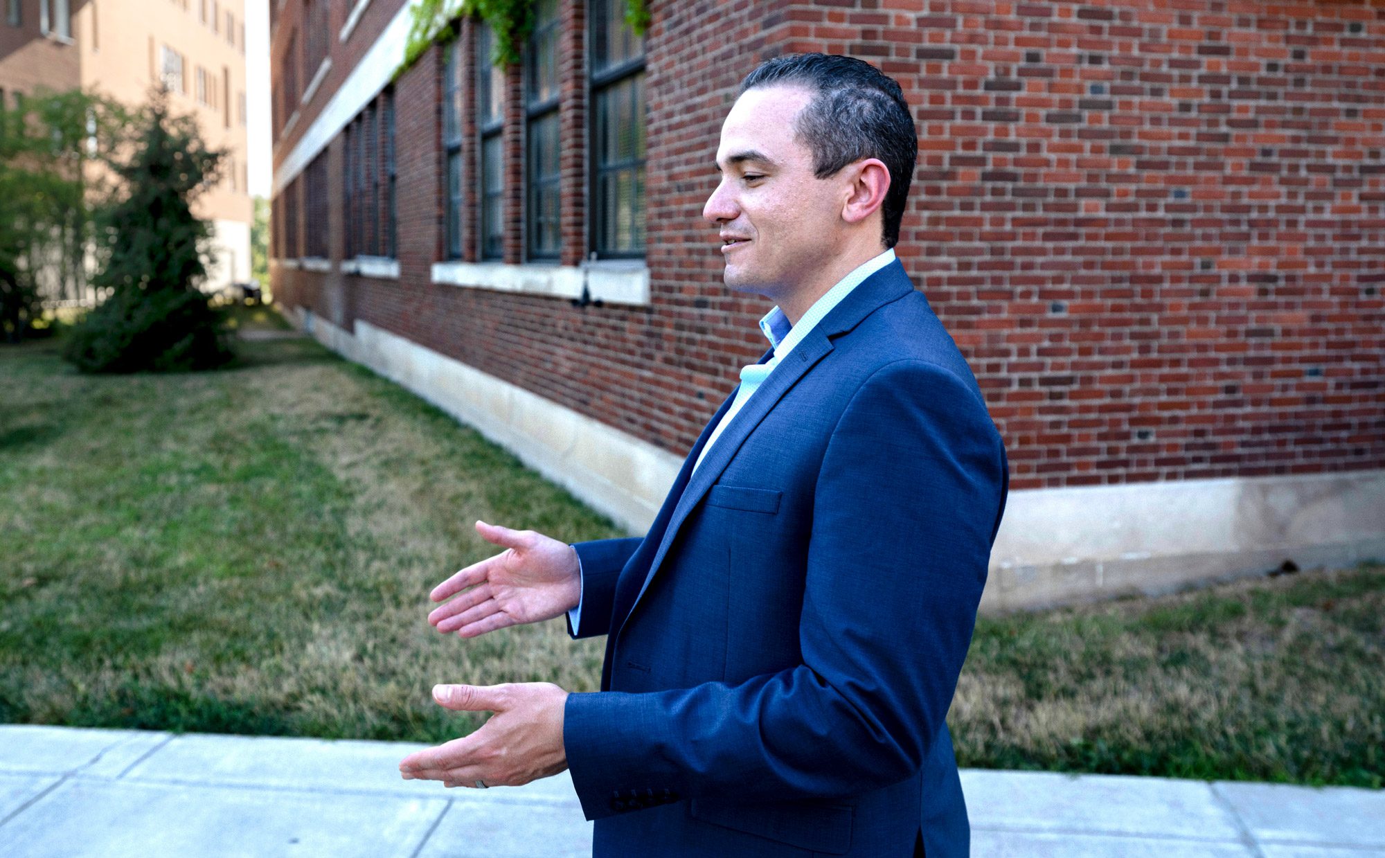 A man walking in a blue sport coat